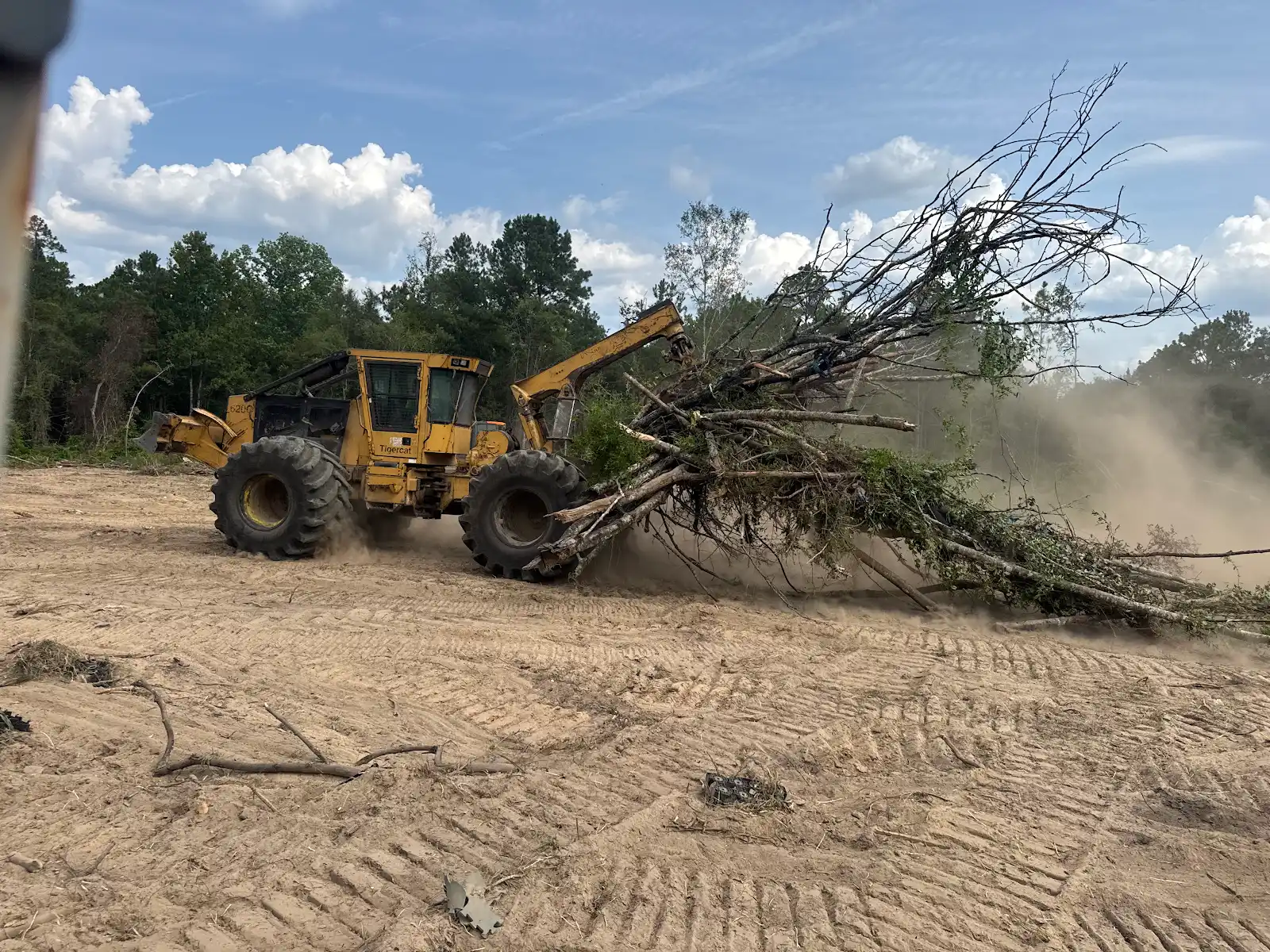Moving cleared timber with heavy equipment